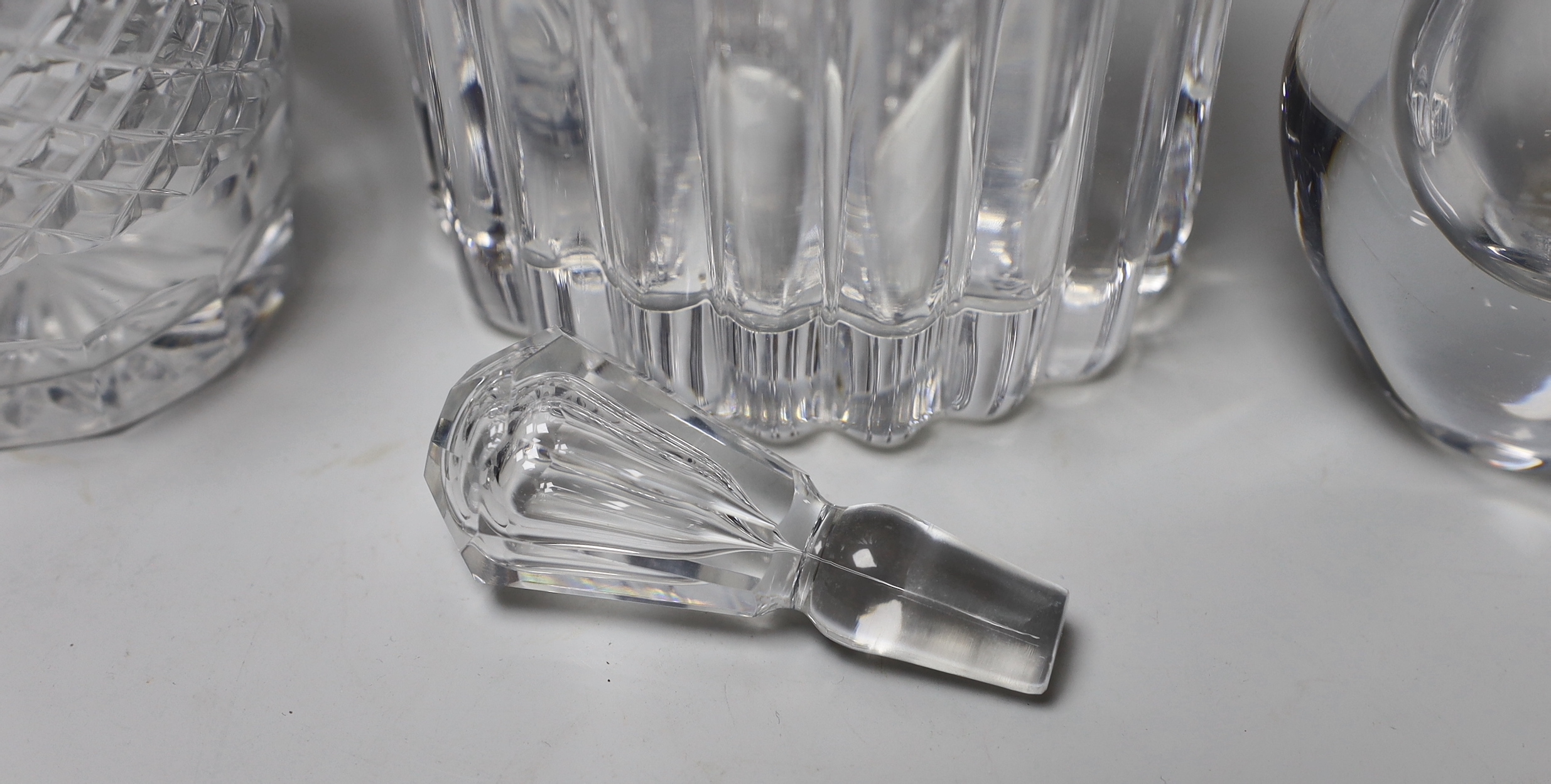 Three pieces of signed glass comprising a Kosa Boda vase by Eden Falk and an Orrefors decanter and vase, the largest 23cm high